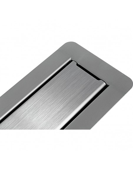 Plain stainless steel cover is included to the drain. It must be covered entirely, with the same material as rest of the floor