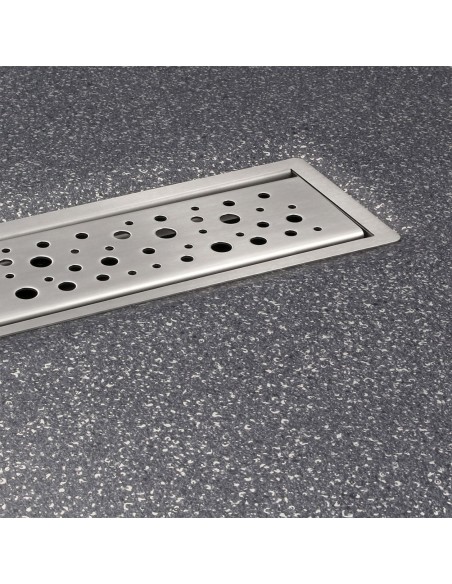 Installed shower drain in dark gray vinyl floor focussed on the visible cover Mistral
