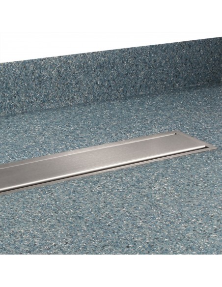 View of a installed wet room tray in blue coloured vinyl flooring with coving, including Ponente cover