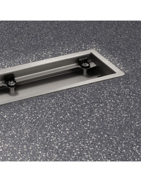 Installed shower drain in dark gray vinyl floor with focus of internal drain body without cover