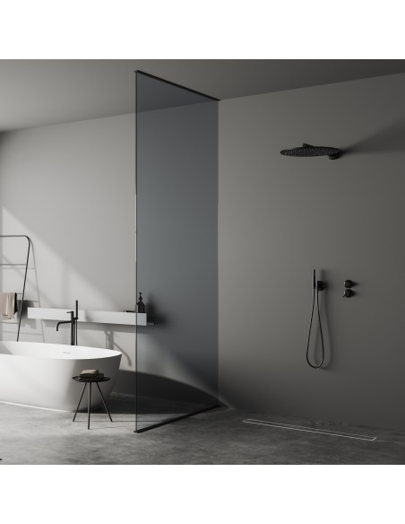 Dark bathroom with microcement floor with a free-standing bath tub and an open shower area - tiled cover side
