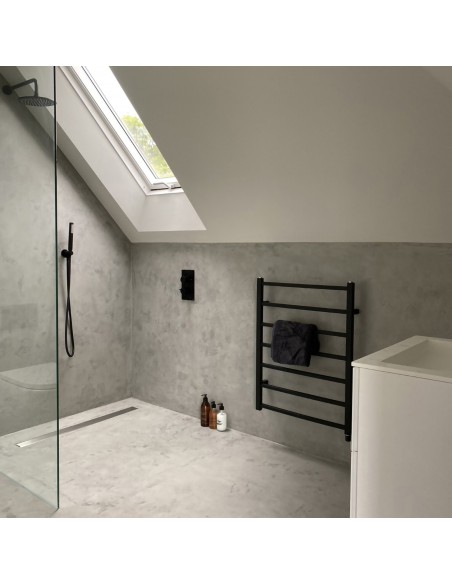 Shower area made of microcement in an industrial look with linear channel and fittings in Silver