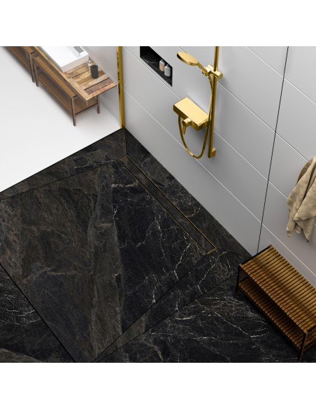 Modern shower area with black marble-look tiles and shower channel and fittings in Brass