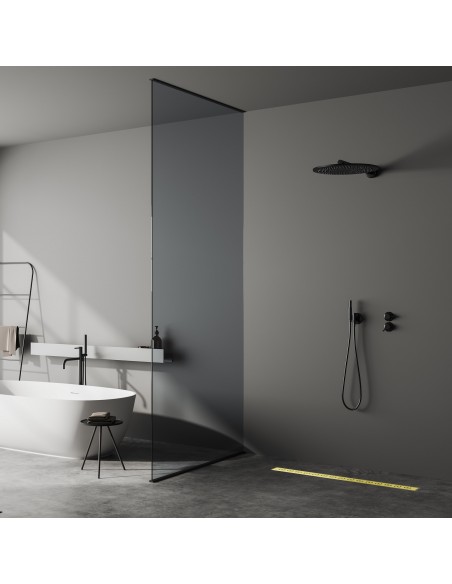 Dark bathroom with microcement floor with a free-standing bath tub and an open shower area
