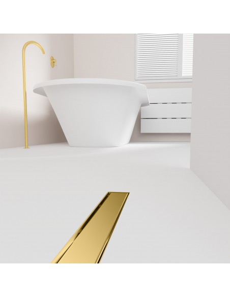 Open bathroom with bathtub and integrated shower drain in Brass in light microcement flooring - solid cover side