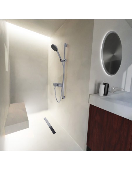 Niche shower area with ceiling lights on bright floor and microcemented walls, with elements in Silver