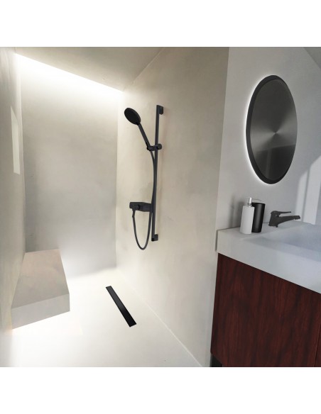 Niche shower area with ceiling lights on bright floor and microcemented walls, with elements in Black