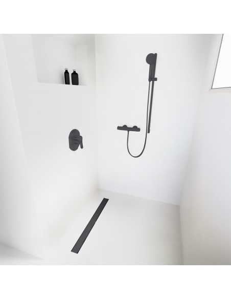Open walk-in shower, surrounded by light-colored microcement floor and walls, with fittings in Black