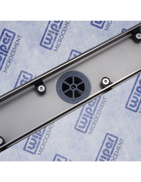 Stainless steel drain body without cover, revealing a centered outlet and adjustable frame for different tile thicknesses
