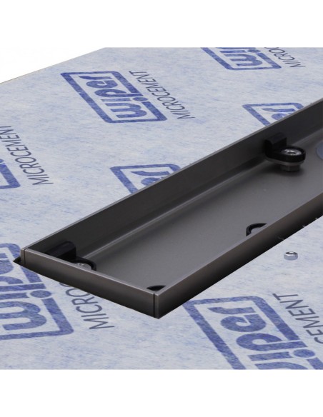 Close up on the drain channel with secondary drainage system and adjustable frame for different tile thicknesses