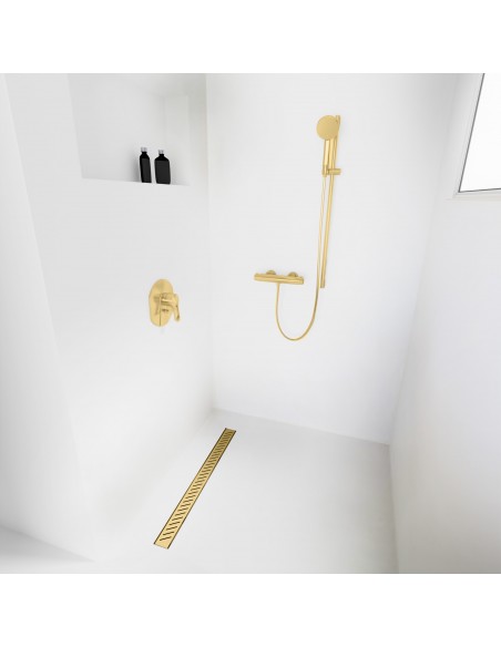 Open walk-in shower, surrounded by light-colored microcement floor and walls, with fittings in Brass