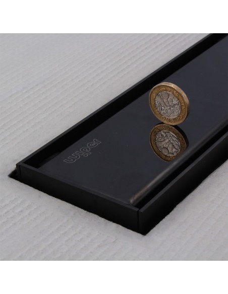 Close up on integrated Black linear drain with matching Ponente cover