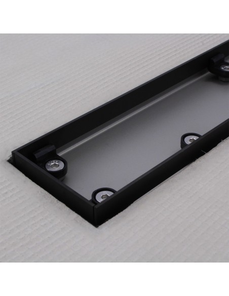 Stainless steel drain body without cover, revealing a centered outlet and adjustable frame for different tile thicknesses