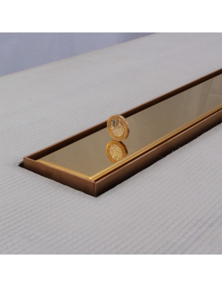 Close up on integrated Brass linear drain with matching Ponente cover