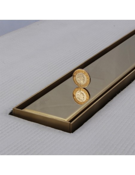 Close up on integrated Gold linear drain with matching Ponente cover