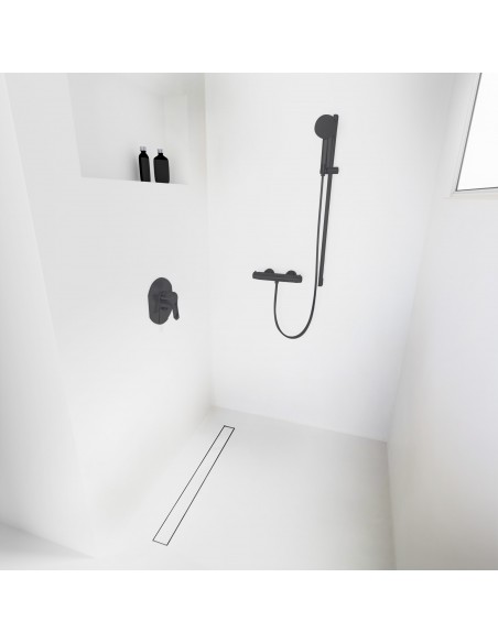 Open walk-in shower, surrounded by light-colored microcement floor and walls, with fittings in Black