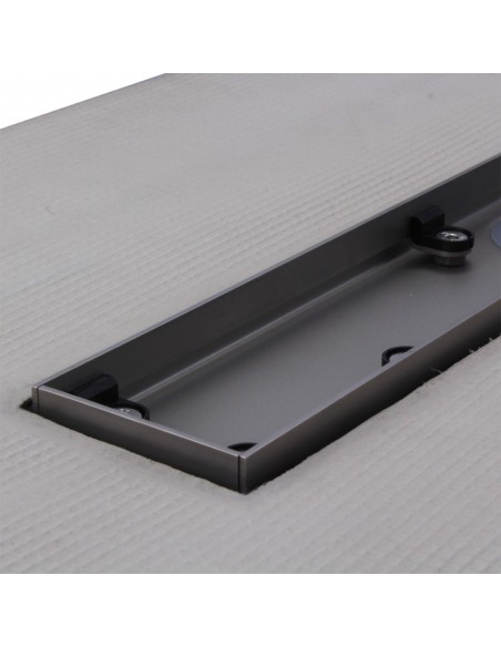Stainless steel drain body without cover, revealing a centered outlet and adjustable frame for different tile thicknesses