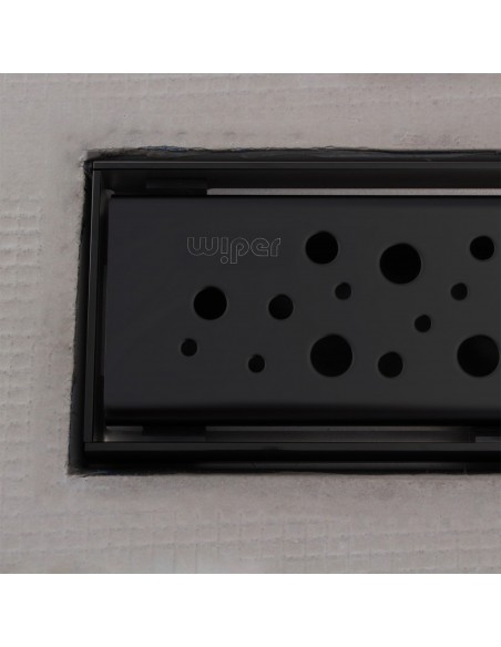 Close up on integrated Black linear drain with matching Mistral cover