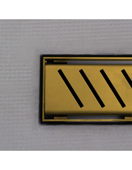 Close up on integrated Brass linear drain with matching Zonda cover