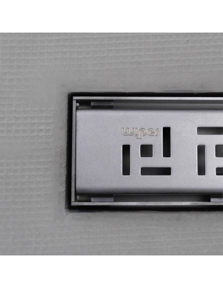 Close up on integrated Silver linear drain with matching Tivano cover