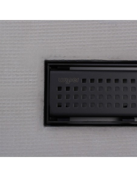 Close up on integrated Black linear drain with matching Sirocco cover