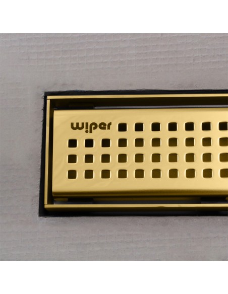Close up on integrated Brass linear drain with matching Sirocco cover