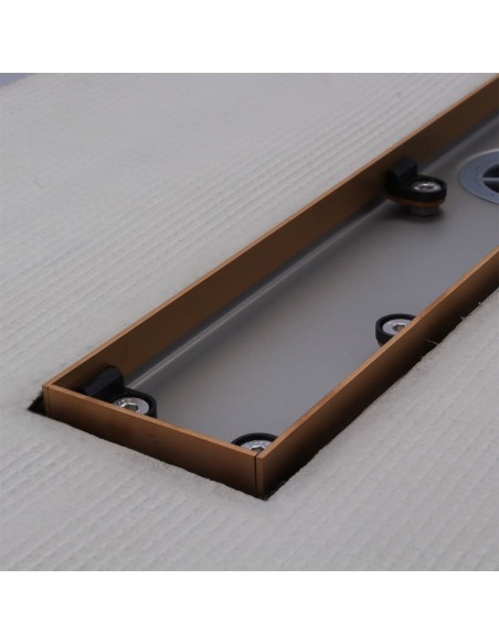 Stainless steel drain body without cover, revealing a centered outlet and adjustable frame for different tile thicknesses