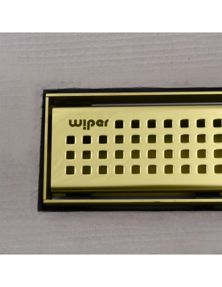 Close up on integrated Gold linear drain with matching Sirocco cover