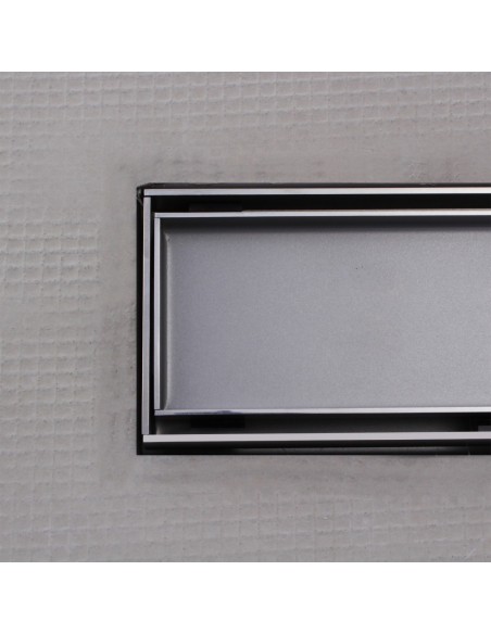 Close up on integrated Silver linear drain with matching Reversible cover