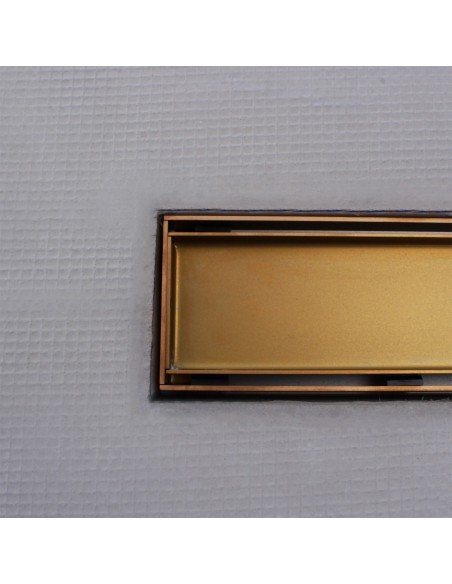 Close up on integrated Brass linear drain with matching Reversible cover