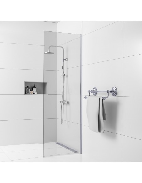 Example of traditional shower area with wall drain, finished with large white tiles and chrome-plated shower fittings